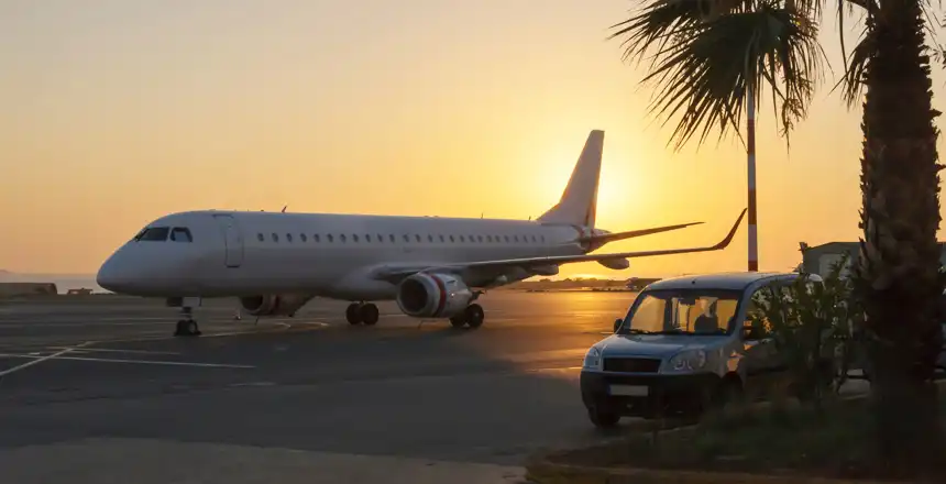 Flugzeug und Auto am Flughafen Heraklion im Sonnenuntergang